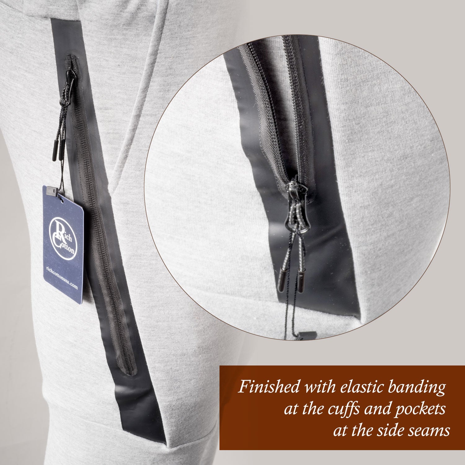 Detail view of athletic joggers showing zippered side pocket with black trim and reinforced stitching
